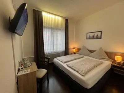 Ein Bett oder Betten in einem Zimmer der Unterkunft Hotel Hüttl