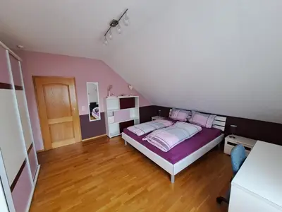 Ein Bett oder Betten in einem Zimmer der Unterkunft Ferienwohnung am Schoosberg, Niederkirchen bei Deidesheim