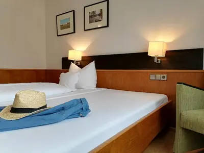 Ein Bett oder Betten in einem Zimmer der Unterkunft Lindner's Hotel