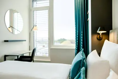 Ein Bett oder Betten in einem Zimmer der Unterkunft Motel One Karlsruhe