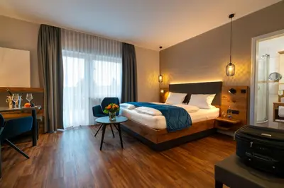 Ein Bett oder Betten in einem Zimmer der Unterkunft Weingut Schreieck VINOTEL & GUTSHAUS
