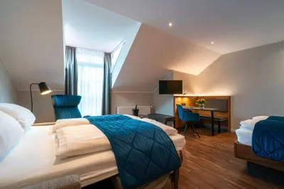 Ein Bett oder Betten in einem Zimmer der Unterkunft Weingut Schreieck VINOTEL & GUTSHAUS