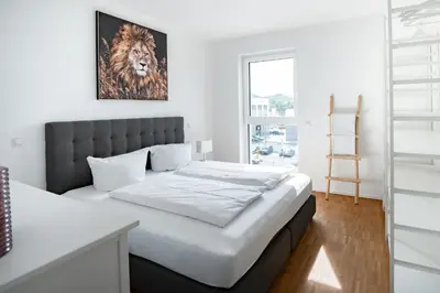 Ein Bett oder Betten in einem Zimmer der Unterkunft Prime Park Family Deluxe Apartment Aschaffenburg