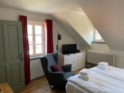 Ein Bett oder Betten in einem Zimmer der Unterkunft Palmbräu Altstadt Appartments
