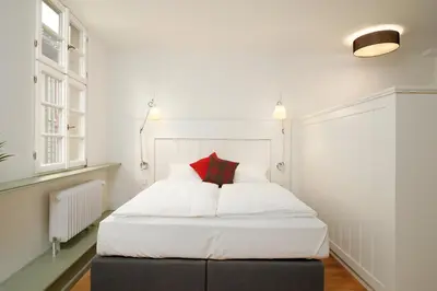 Ein Bett oder Betten in einem Zimmer der Unterkunft Palmbräu Altstadt Appartments